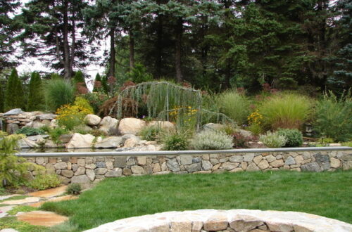 Bolton Landscape Design & Masonry specializing in plantings, sprinkler systems, patios, grills, driveway construction, and grading since 1979.