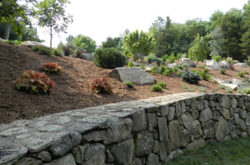 Bolton Landscape Design & Masonry specializing in plantings, sprinkler systems, patios, grills, driveway construction, and grading since 1979.