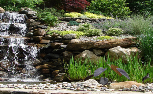 Bolton Landscape Design & Masonry specializing in plantings, sprinkler systems, patios, grills, driveway construction, and grading since 1979.